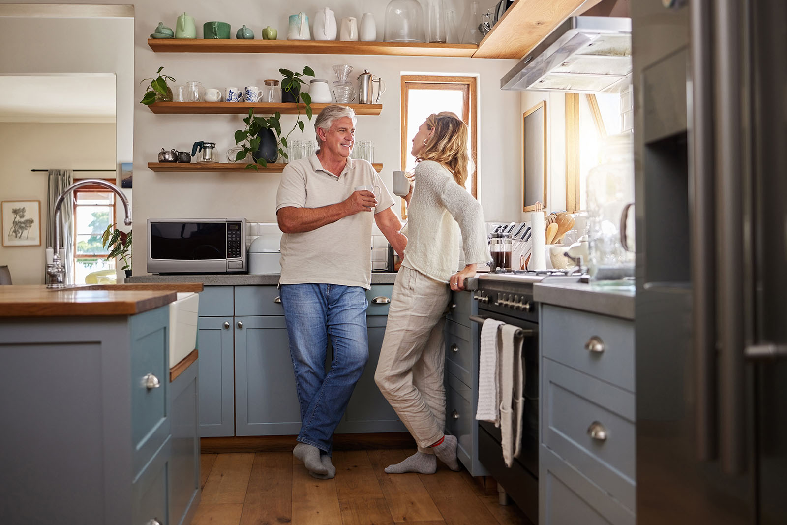 Older couple laughing in the kitchen of their new home